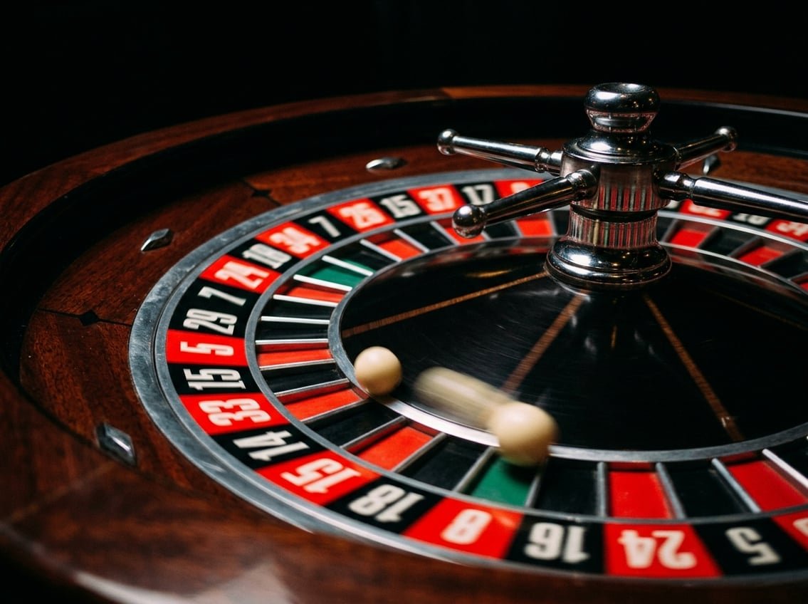Close-up of red and black roulette wheel with ball spinning